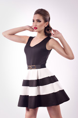 Portrait of beautiful young woman with makeup in fashion clothes