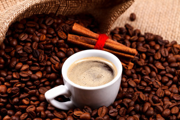 Coffee with cinnamon on coffee beans