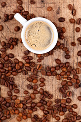Cup of coffee with coffee beans