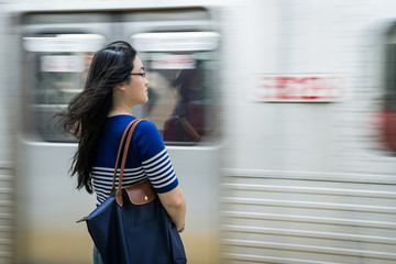Young woman waiting at subway station