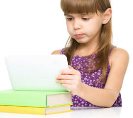 Young girl is using tablet