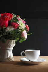 flower ,coffee cup  on cork board