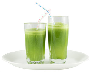 Green vegetable juice in the glasses with straws