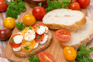 ciabatta with mozzarella and colorful cherry tomatoes, top view