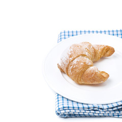 fresh croissant on a plate, isolated