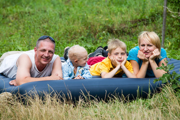 Fototapeta premium Happy mother, father and two sons in the park