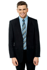 Smiling businessman posing casually