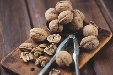 Walnuts on a rustic wooden chopping board, horizontal shot