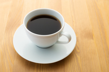 Obraz na płótnie Canvas Cup of coffee on wooden table