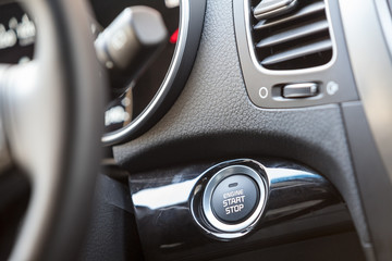 Obraz na płótnie Canvas Car interior, engine start button under steering wheel