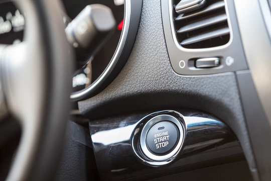 Car interior, engine start button under steering wheel