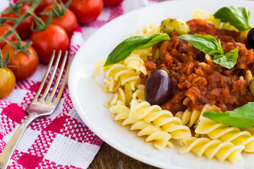 Pasta with tomato souse, olives and basil
