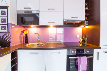 Interior of modern white and purple kitchen