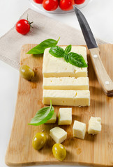 Feta cheese on a wooden platter