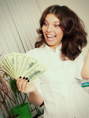 financial success.girl holds a pack of dollars