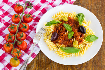 Pasta with tomato souse, olives and basil