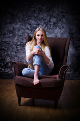 Young girl on grey wall