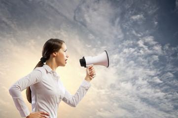 Businesswoman screaming in megaphone