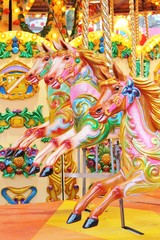 carousel merry-go-round painted horses - Stock Photo