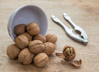 walnuts in a bowl and nutcracker