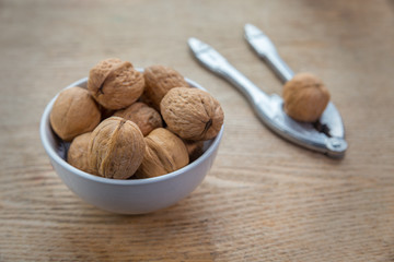 walnuts in a bowl and nutcracker