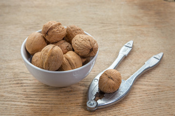 walnuts in a bowl and nutcracker