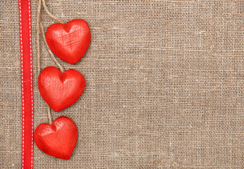 Wooden hearts on the burlap