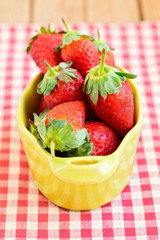 Fresh strawberry on checked tablecloth