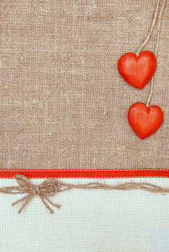 Valentine card with red hearts and ribbon