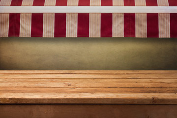 Empty wooden table with awning background