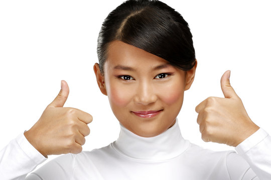 Beautiful happy asian girl showing thumbs up