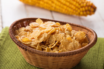 Cornflakes in bowl on table