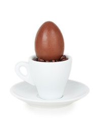 chocolate egg on a white cup and saucer