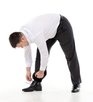 Man bending down to do up his shoelaces
