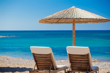 view of the beach with chairs and umbrellas