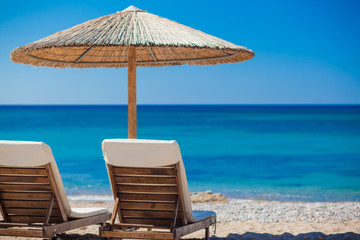 view of the beach with chairs and umbrellas