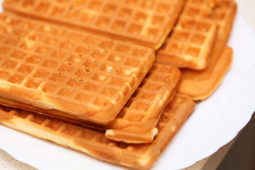 Stack of sweet belgian waffles on plate