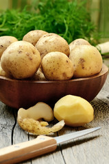 Raw potatoes on wooden table