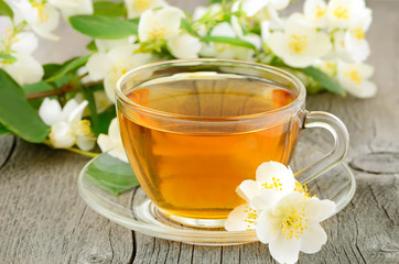 Cup of herbal tea with jasmine flowers