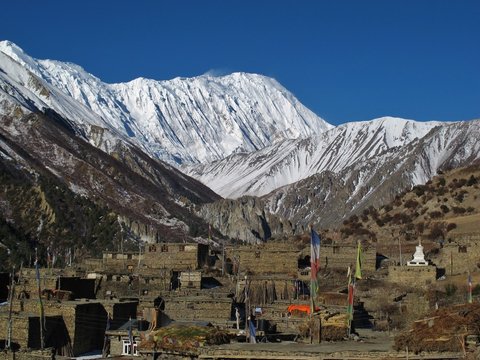 Old houses of Khangsar and snow capped Tilicho Peak