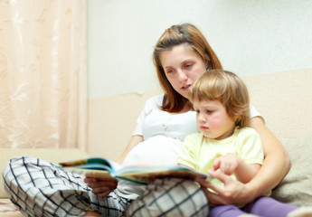 Mother and child reading  book