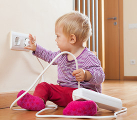 Toddler playing with electricity