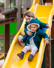Fototapeta na wymiar two happy children on slide