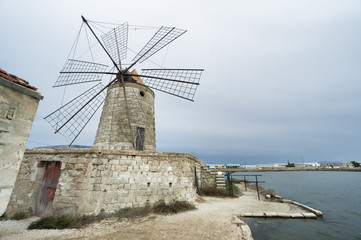 Fototapeta na wymiar Salina wiatrak w Trapani, Sycylia, Włochy.