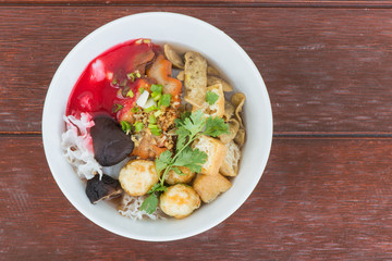 Thai vegetarian food called noodle soup on wooden background