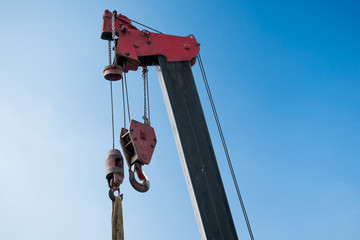 An empty crane in a construction site under the blue sky