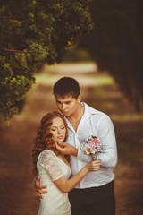 Portrait of young beautiful redhair woman standing in green park