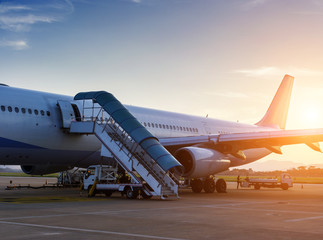 Naklejka na ściany i meble Airplane near the terminal in an airport