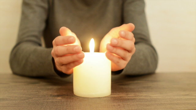 hands and candle