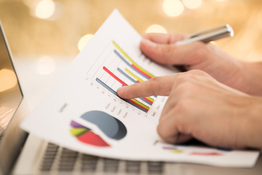 Businessman analyzing investment with laptop